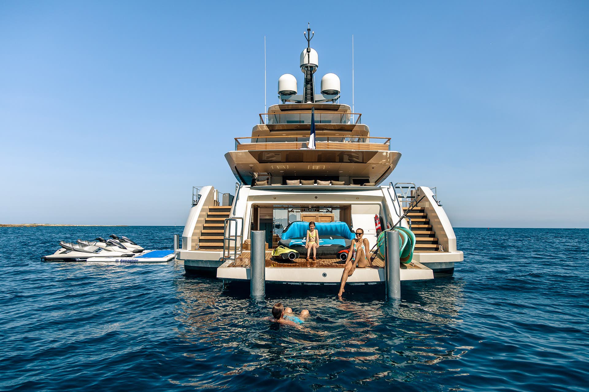 family having fun onboard luxury superyacht SOLO beach club in the mediterranean sea